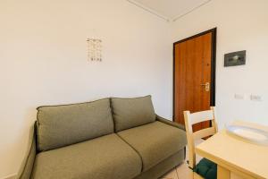 a living room with a couch and a table at Small paradise a few meters from the sea in Le Vecchie Saline