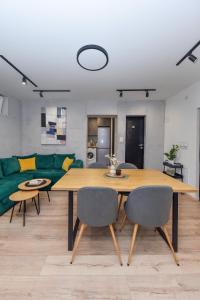 a living room with a table and a green couch at Industrial Hostel Vila Jovana in Odžaci +71 photos
