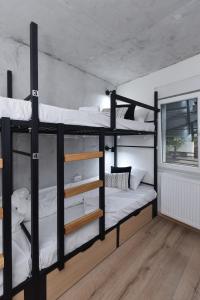 two bunk beds in a room with a window at Industrial Hostel Vila Jovana in Odžaci +71 photos