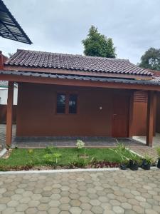 a small house with a red roof at Gifal Surf Camp & Cottage in Wainapal