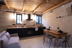 a living room with a table and a kitchen at la stalla di mario in Perondo +35 photos