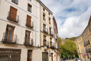 a tall building with balconies on a city street at Calderón de la Barca By Cuencaloft in Cuenca