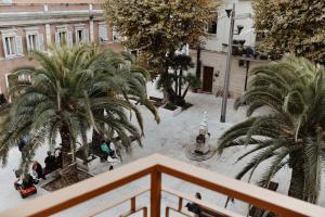 a view of a courtyard with palm trees in the snow at Suite Grottabeach a due passi dal mare in Grottammare