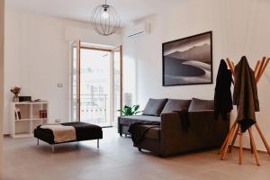 a living room with a couch and a bed at Suite Grottabeach a due passi dal mare in Grottammare