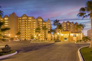 a large building with palm trees in a parking lot at Sonoran Sea in Campo del Medio