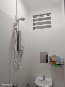 a white bathroom with a sink and a window at HoMestaY Kulim Seri Rambai in Kulim