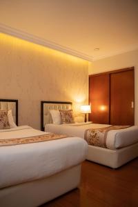 a hotel room with two beds in a room at Tolip Olympia Hotel in Addis Ababa +40 photos