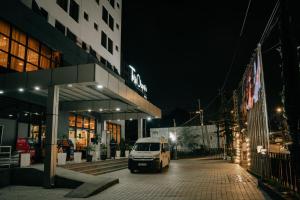 a van parked in front of a building at night at Tolip Olympia Hotel in Addis Ababa