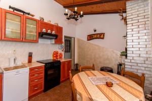 a kitchen with a table and a stove top oven at House Nicol Fazana in Fažana