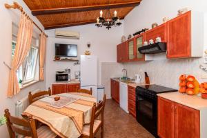 a kitchen with a table and a dining room at House Nicol Fazana in Fažana +18 photos