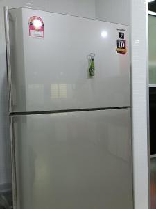 a refrigerator in a kitchen with magnets on it at 主人房玻璃市港口 in Kuala Perlis
