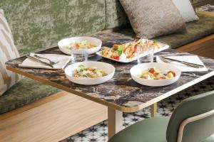 a table with four bowls of food on it at B&B HOTEL Venezia Laguna in Venice