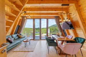 a living room with a table and a couch at TheViewResort in Zlatibor