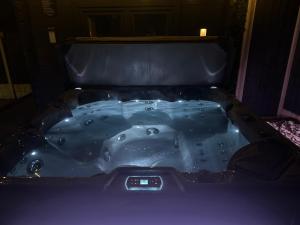 a jacuzzi tub in a dark room at Modern Retreat with Hot Tub and Cinema in Cuckney +68 photos