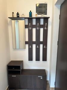 a dressing room with a mirror and a dresser at studio apartman elegant in Vrnjci