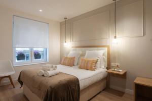 a bedroom with a bed with two stuffed animals on it at Pension Del Mar in Donostia-San Sebastián