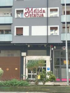 a building with a sign on the side of it at Melida Ostatua in Ermua