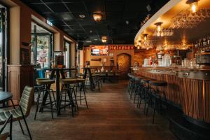 a bar with bar stools in a restaurant at Hotel Hulsman in Venray +7 photos