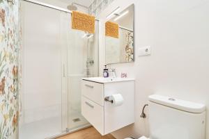 a white bathroom with a shower and a toilet at El Rincón de Dorcica Ruiz in Frigiliana +13 photos