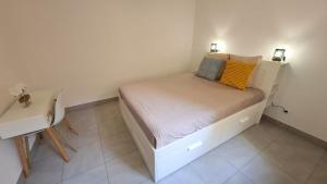 a small bedroom with a bed with two pillows on it at Beautiful 43m2 with two double beds everything nearby in Nice