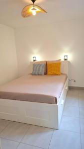 a white bed with two pillows on it in a room at Beautiful 43m2 with two double beds everything nearby in Nice