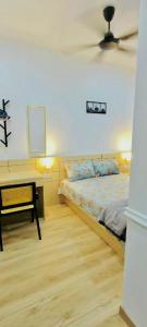 a bedroom with a bed and a desk with a ceiling at Homestay DEEDORA in Seri Manjung