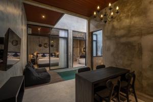 a room with a dining table and a bedroom at Nauti Villa in Ubud +14 photos