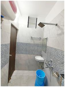 a bathroom with a toilet and a sink at Hotel Shreemahavia Home # Town Near Jagannath Temple and Sea Beach -Fully Air conditioned - Lift Wifi- And Parking Facilities -Excellent Customer Service Awarded -Best Seller in Puri