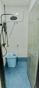 a bathroom with a blue toilet in a room at Homestay DEEDORA in Seri Manjung