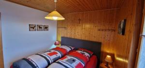 a row of pillows on a bed in a room at Narcisse 15 in Champoussin