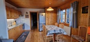 a kitchen with a table and chairs in a room at Narcisse 15 in Champoussin +5 photos