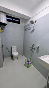 a bathroom with a toilet and a sink at Naku homes in Dirang Dzong