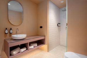 a bathroom with a sink and a mirror at Akeah Porto Centro in Porto +38 photos