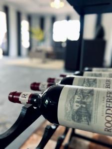 a bottle of wine sitting on top of a table at ED Holiday Home- Chobe in Lesoma