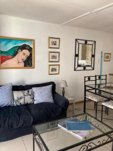 a living room with a couch and a table at Constantia Lazy River in Cape Town