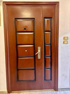 a wooden door with several shelves on it at Nile House in Maadi N4 in Cairo