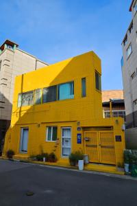 a yellow building on the side of a street at 스테이 노랑 stay norang in Daegu