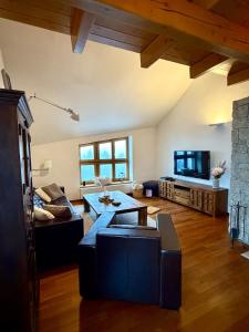 a living room with a couch and a table at Chalet close to the Clouds in Špindlerův Mlýn