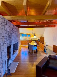 a living room with a stone fireplace and a table at Chalet close to the Clouds in Špindlerův Mlýn