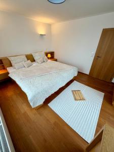 a bedroom with a large bed and a wooden floor at Chalet close to the Clouds in Špindlerův Mlýn