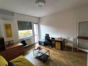 sala de estar con mesa y escritorio en Bagaini Urban Flat, en Varese