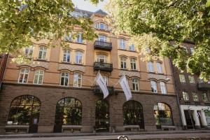 a building on the corner of a street at Home Hotel Norre Park in Halmstad