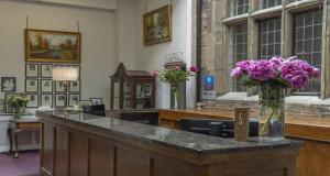 a vase of purple flowers sitting on a counter at Castle Bromwich Hall Hotel, BW Signature Collection by Best Western in Birmingham