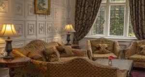 a living room with a couch and two chairs at Castle Bromwich Hall Hotel, BW Signature Collection by Best Western in Birmingham
