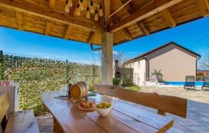 a wooden table with a bowl of fruit on a patio at Villa Lemily with private pool by Villas Guide in Lipa
