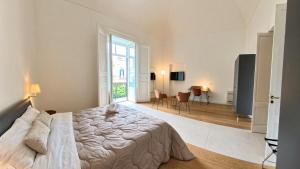 a bedroom with a large bed and a large window at Sui Lecci in Matera