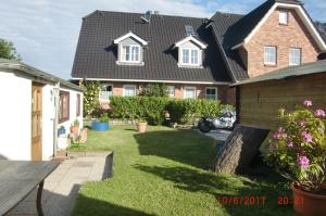 a brick house with a black roof at Ferienhaus Gisa in Süderende