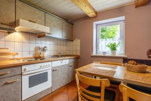 una cucina con un tavolo e una stufa forno superiore di Flieder a Westermarkelsdorf Altre 17 foto