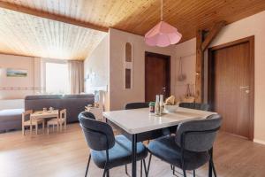a dining room and living room with a table and chairs at Linde in Westermarkelsdorf