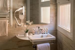 a bathroom with a white sink and a mirror at Rome Visits in Rome